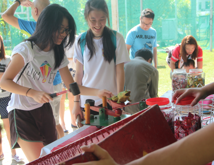 Students trying out various games at the Founder's Day Carnival